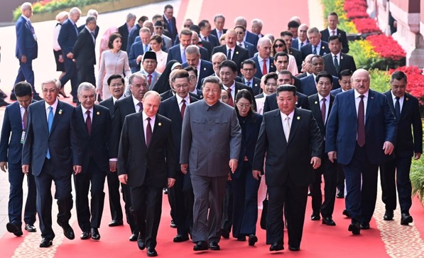 U.S. president disparages nuclear-armed troika’s show of force beneath Mao’s portrait